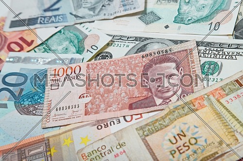Background from paper money of the different countries. Colombian peso in the middle