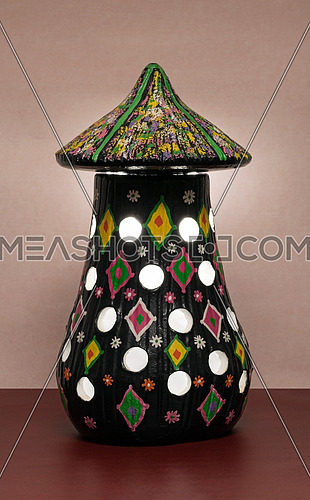 Illuminated black painted perforated pottery table lamp