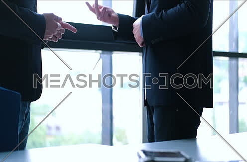 Portrait smiling businessman shaking hands with clients at end of meeting 