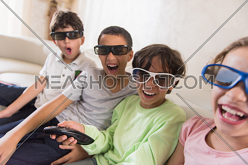 happy middle eastern children watch 3D movies and enjoy in cheerful moments on the sofa
