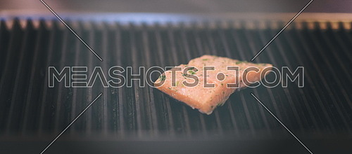 Salmon fillets cooking on grill