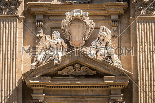 In the picture a marble statue of the Middle Ages showing two women, in the historic center of Florence.