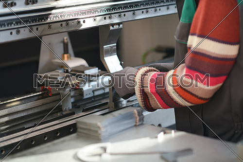 close up woman hand working in a modern factory and preparing material for a CNC machine. . High quality photo