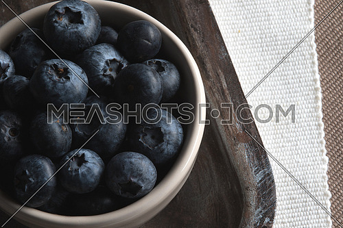 Blueberries in White bowl on a tray