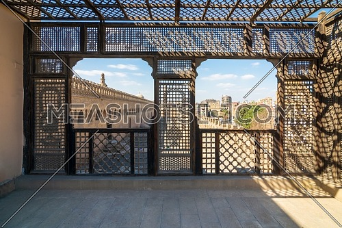 Passage surrounding the Mosque of Ibn Tulun framed by interleaved wooden perforated wall, Mashrabiya, Medieval Cairo, Egypt