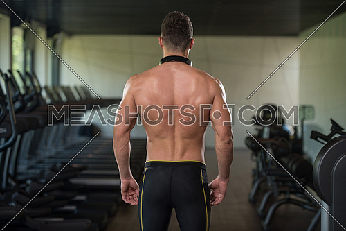 Portrait Of A Physically Fit Man Posing In Modern Fitness Center Gym