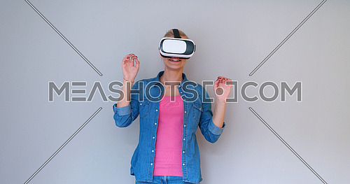 Happy girl getting experience using VR headset glasses of virtual reality, isolated on white background