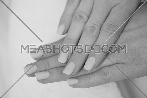 Beautiful fingers with french manicure on the towel. Manicure in a beauty salon.