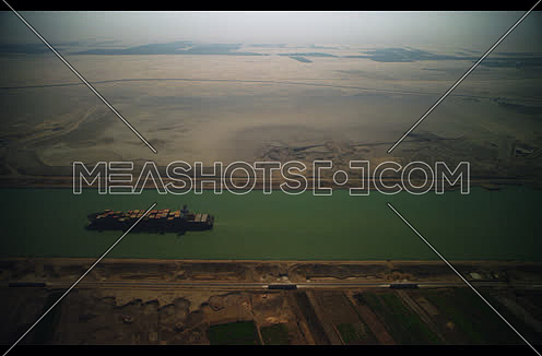 Arial shot for Cargo Ship sailing in Suez Canal at day