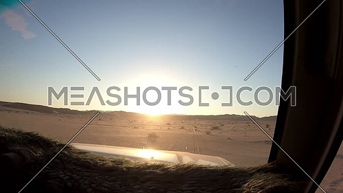 Inside shot from a car driving on the route in Sinai Ain Hadouda Desert at sunset