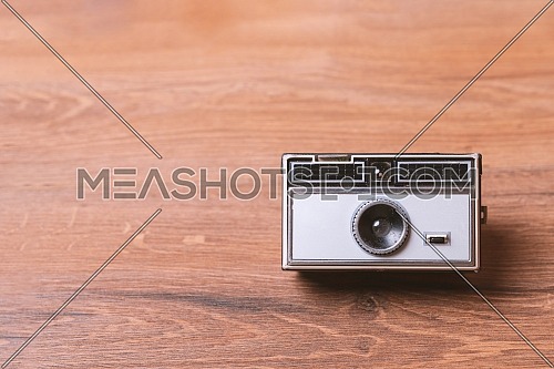 Retro classic 35mm photo camera on wooden Background
