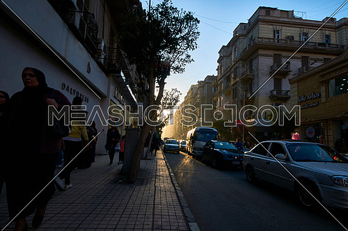 Long shot for pedestrain walking at sidewalk at cairo at Day