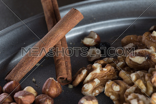 walnuts hazelnut cinnamon stick on a tray