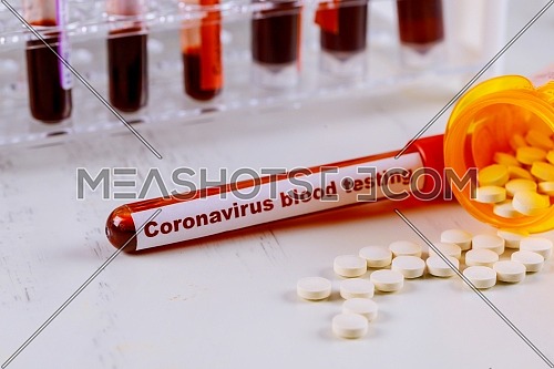 Coronavirus chinese infection blood sample test with pills, tablets blood test in Laboratory
