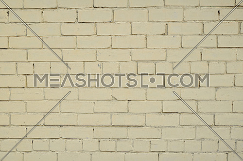Yellow beige painted pale old brick wall texture background