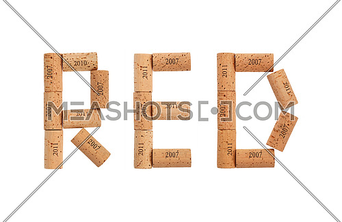 Word RED shaped by natural wooden wine bottle corks of different vintage years isolated on white background