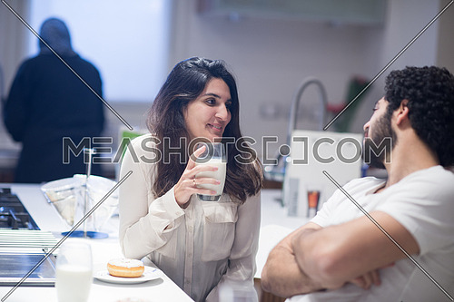 Young middle east couple eating a meal and happily spends time in the kitchen
