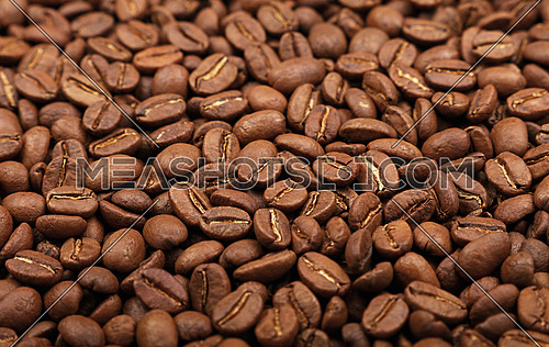 Roasted brown Arabica coffee big beans background pattern, close up, high angle view