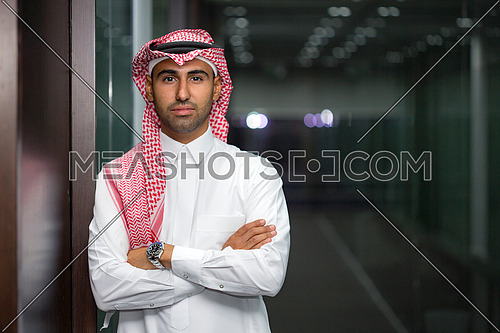 Saudi man standing next to his office