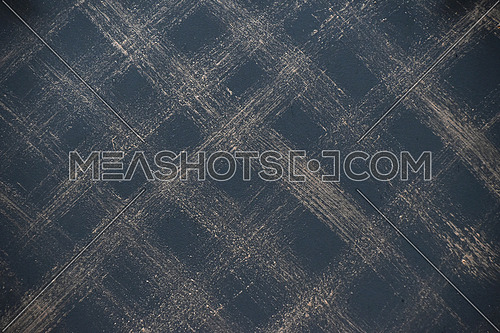 Metal surface texture background painted with black with brushed traces forming checkered pattern