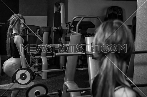 Young Woman Performing Dumbbels Squats - One Of The Best Bodybuilding Exercise For Legs