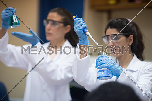 Young middle eastern women doing a bit of research testing the samples in modern laboratories