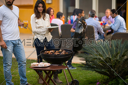 happy middle east family enjoying the beautiful summer afternoon with a barbecue in the garden