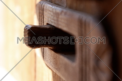 A macro shot of a wooden door Handle