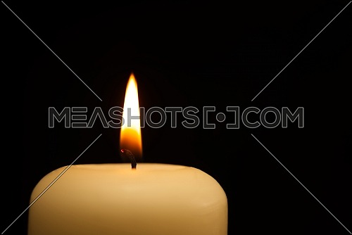 Candle burning in the darkness. Conceptual image with copy space