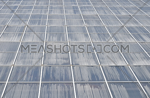 Greenhouse plastic glass framed wall of windows fog up surface in perspective
