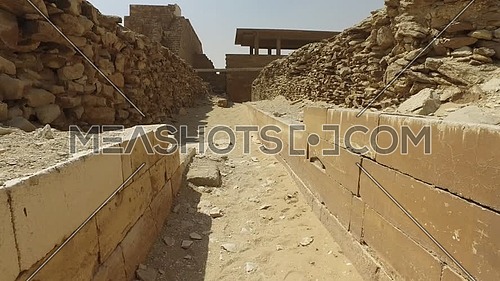 Walk through ancient pharaonic ruins in Saqqara Area at day.