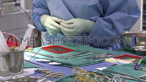 medium shot for nurse Preparing surgical instruments
