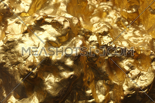 Close up big gold rock slug nugget uneven surface