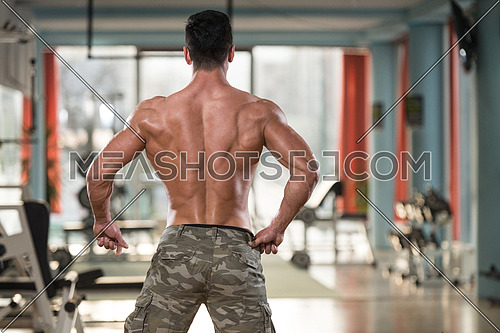 Portrait Of A Physically Fit Young Man In Modern Fitness Center