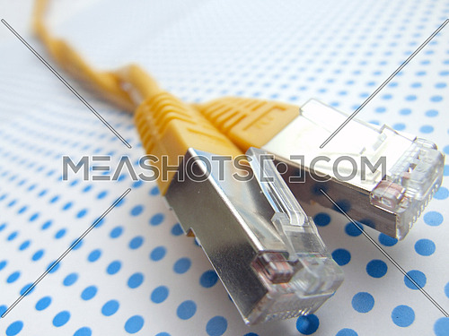 yellow ethernet cable on dotted background