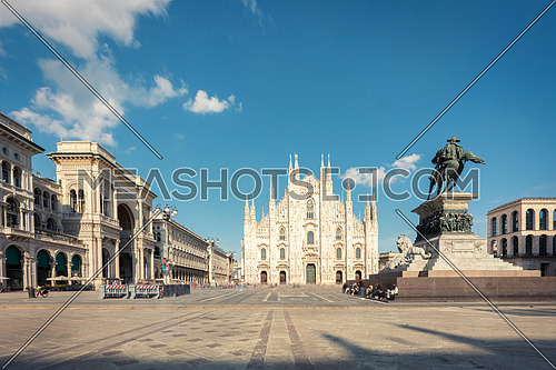 Long exposure of Milan cathedral Duomo and Vittorio Emanuele statue in Square "Piazza Duomo" at sunny day and clouds, Milan, Italy.