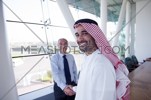 arabian businessmans make deal and handshake with company director at modern meeting room