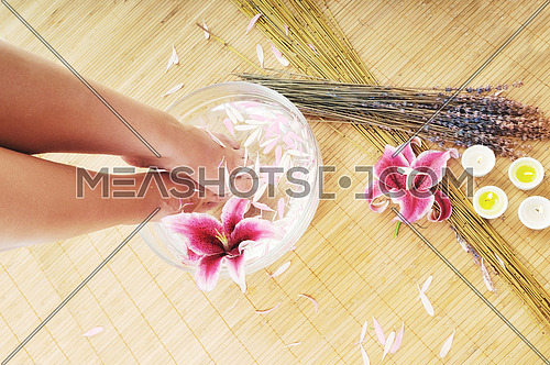 woman spa pedicure foot treatment with water and flower