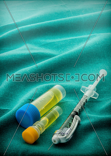 Some Vials And Syringe On Operating Table
