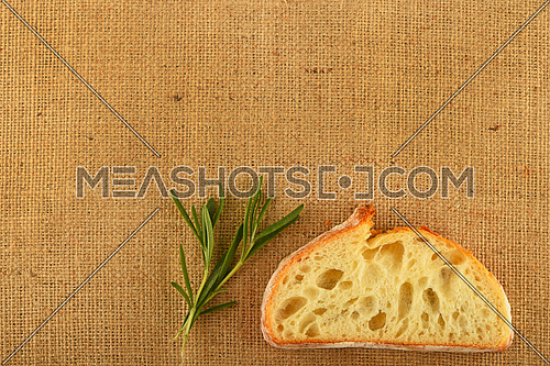 Jute canvas with rosemary leaves and slice of white wheat bread, add your text