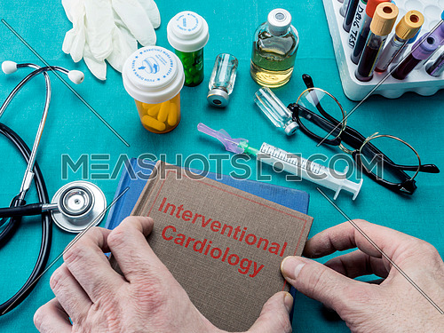 Doctor holds surgical intervention book, conceptual image