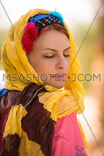 portrait of a young beautiful middle eastern woman with a smile on her face on a sunny summer day