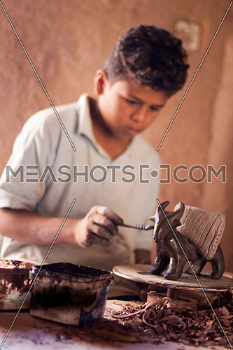 Young boy at pottery school in Tunis Village, Fayoum, Egypt