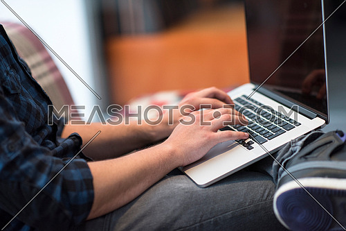 technology, home and lifestyle concept  of man working with laptop computer and sitting on sofaa
