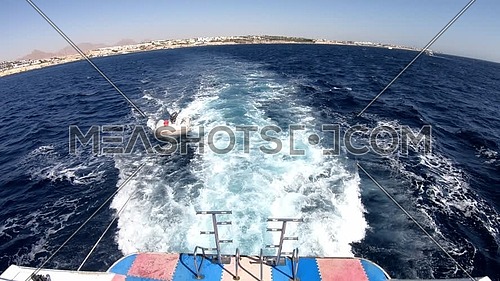 Long shot for backside boat showing Sharm El Shaikh City and Inflatable boat
