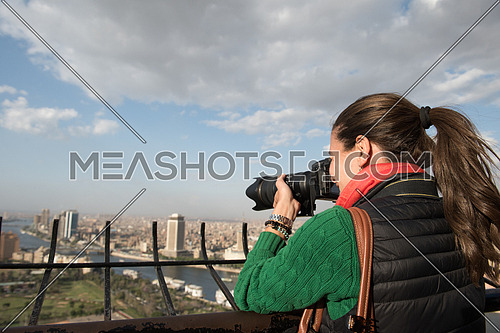 female tourist taking photos from cairo tower at beautiful sunny day