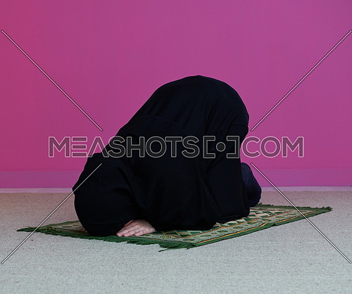 Muslim woman in namaz praying for Allah muslim god. Muslim woman on the carpet praying in traditional middle eastern clothes, Woman in Hijab