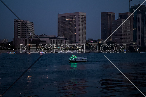 Long shot for the River Nile at Magic Hour showing buildings and motor boat