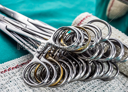 Surgical scissors on a bandage, conceptual image, horizontal composition