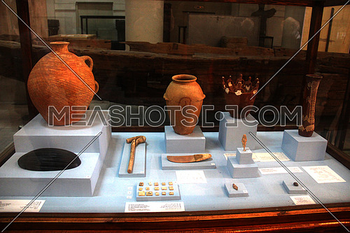 a photo from inside the Egyptian museum showing tools & pots used by the ancient Egyptians during the Pharaoh civilization
